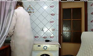 Hot hostess Lukerya in the kitchen in a dressing gown.