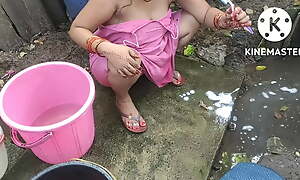Indian dwelling-place wife bathing outside