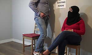 Muslim woman quibbling not far from public hang back room